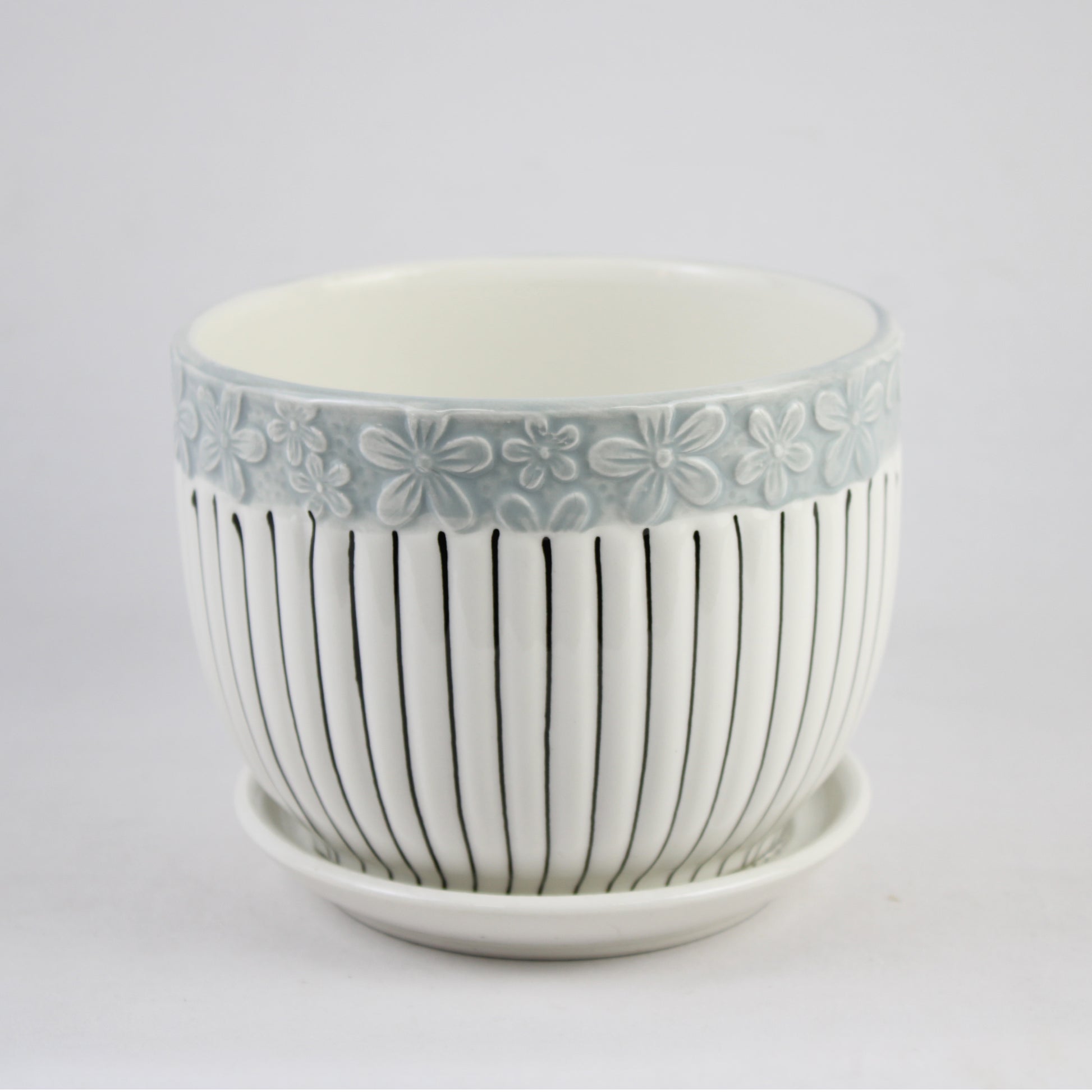 Decorative ceramic pot with floral pattern on a white background